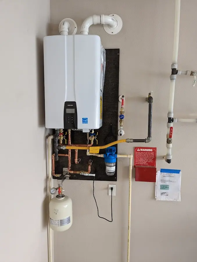 Professional plumber installing copper piping in a Menomonee Falls home